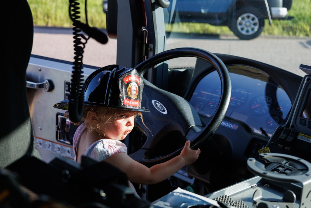 Young girl seated in fire engine